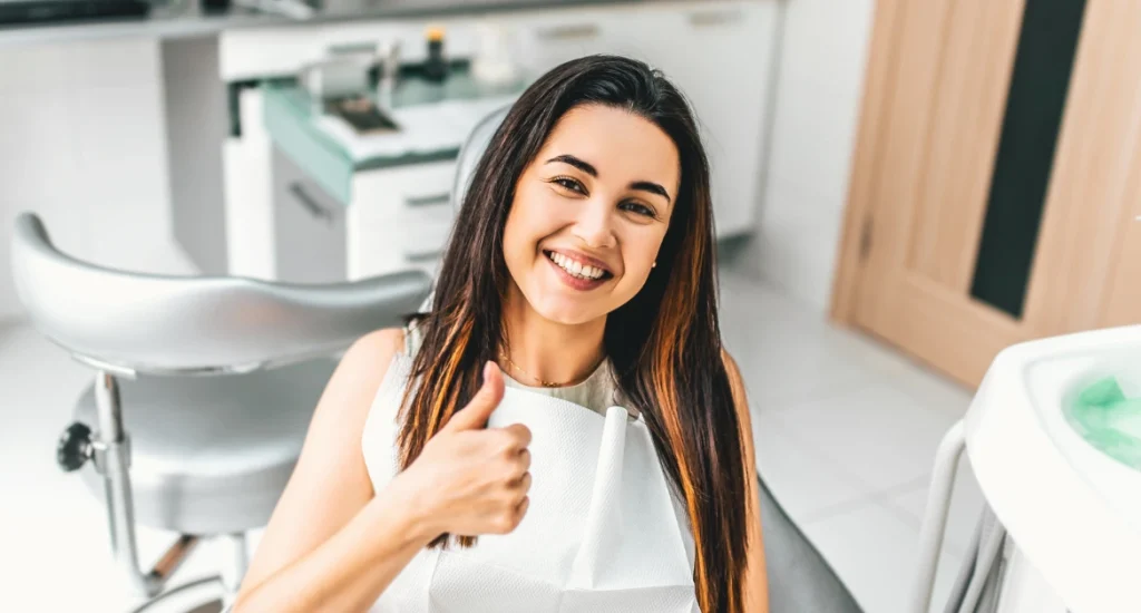 Happy Dental Patient Giving Thumbs Up After Appointment
