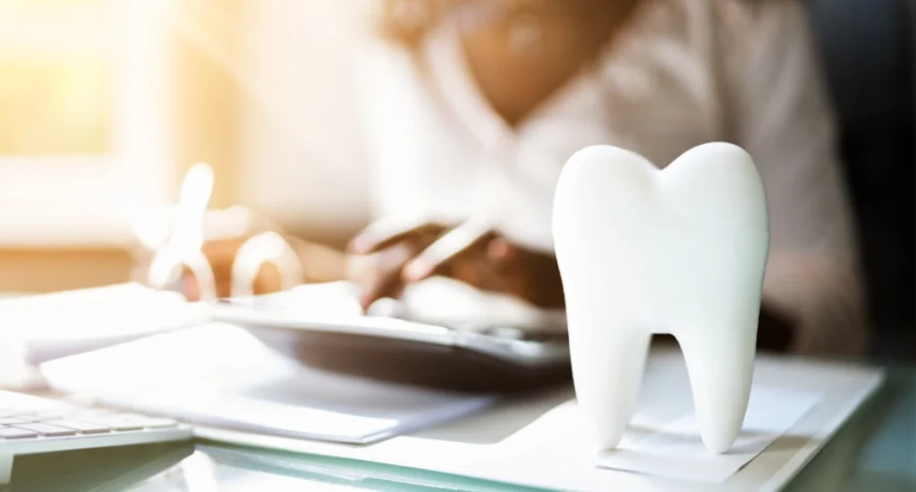 Dental Consultation Desk with Tooth Model and Patient Paperwork